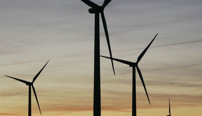 
              FILE - In this March 11, 2009 file photo, a wind mill, rear center, supplies water to a stock tank, surrounded by wind turbines of the Smoky Hills Wind Project near Wilson, Kansas. Tuck
